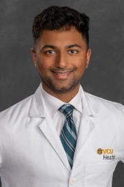 Asim Shafique, D.O. in white coat